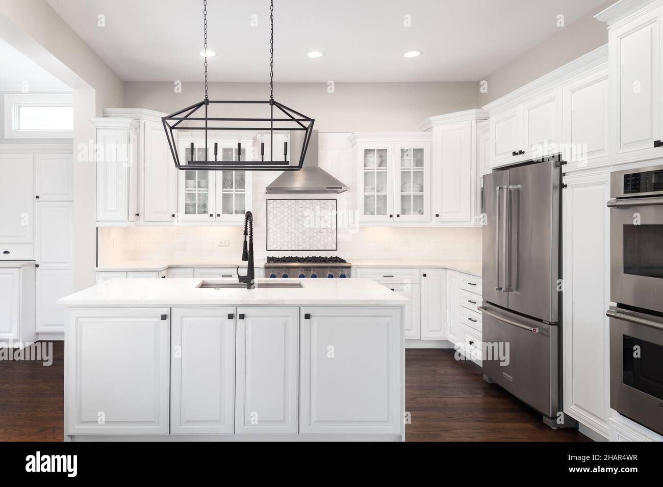 A beautiful, modern kitchen with white stainless steel
