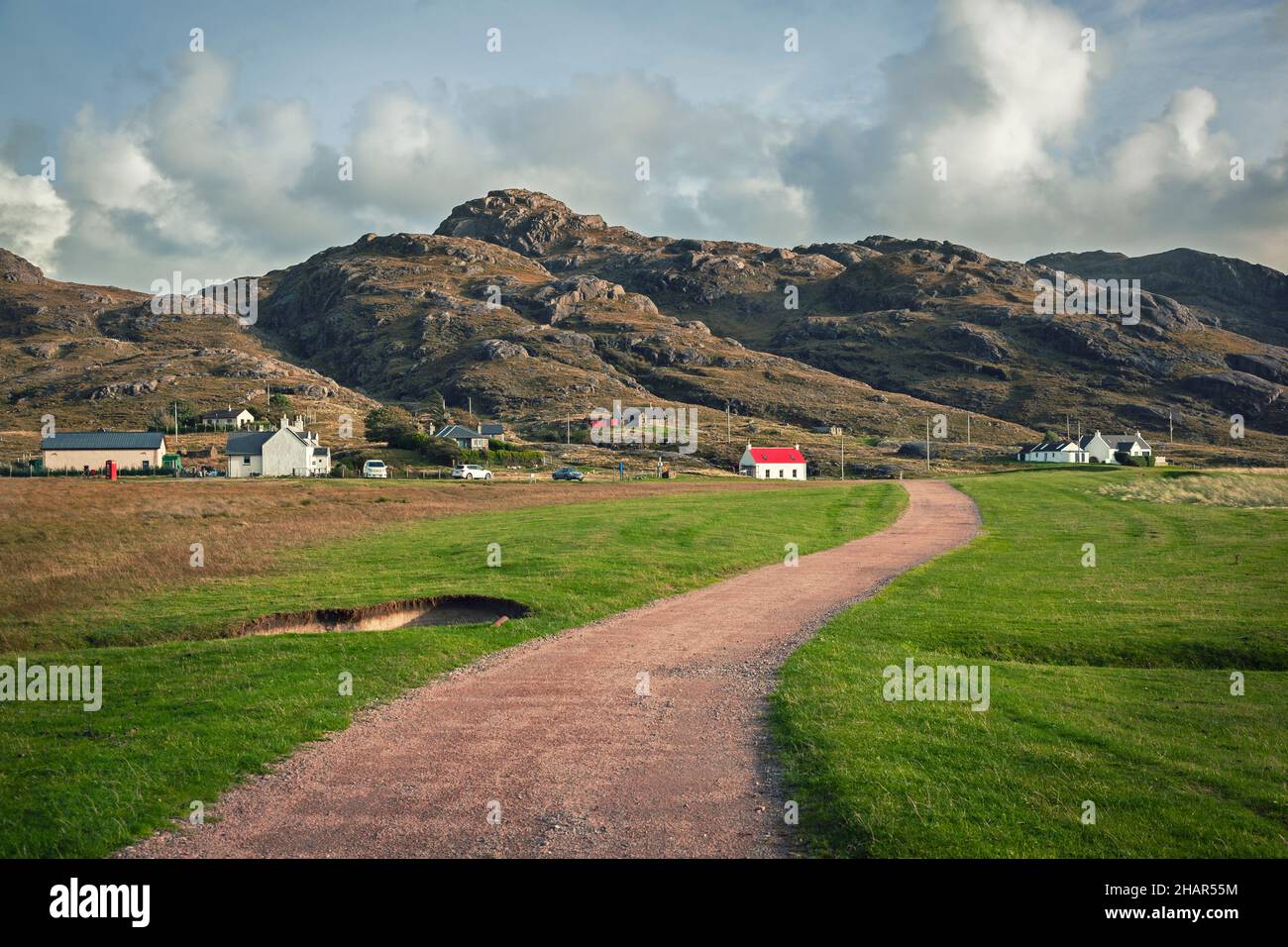 Houses at Sanna Bay sit along the base of a rugged hill range near to the most westerly point of Great Britain on the Ardnamurchan Peninsula. Scotland Stock Photo