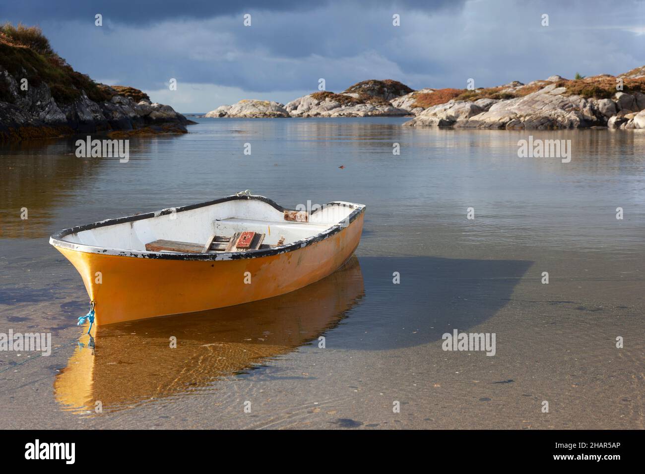 A rowing boat rises on the incoming tide at an Ardtoe sandy cove on the west coast of the Arnamurchan Peninsula, West Scotland Stock Photo