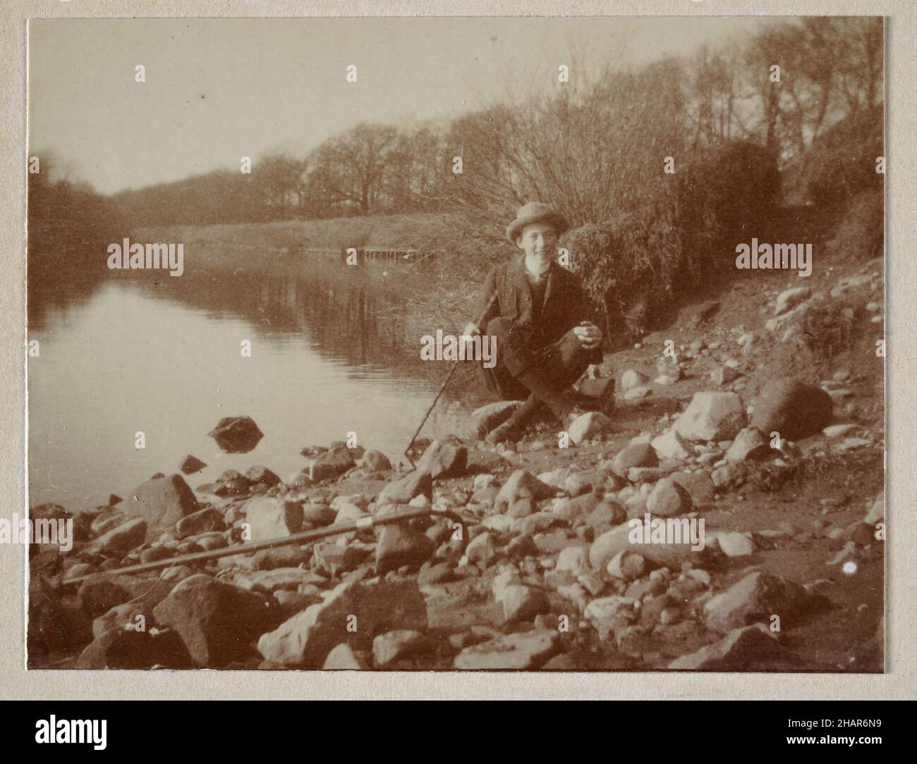 Vintage photograph of a Teenage boy sitting by a river, countryside, North Yorkshire, Edwardian England 1905 Stock Photo