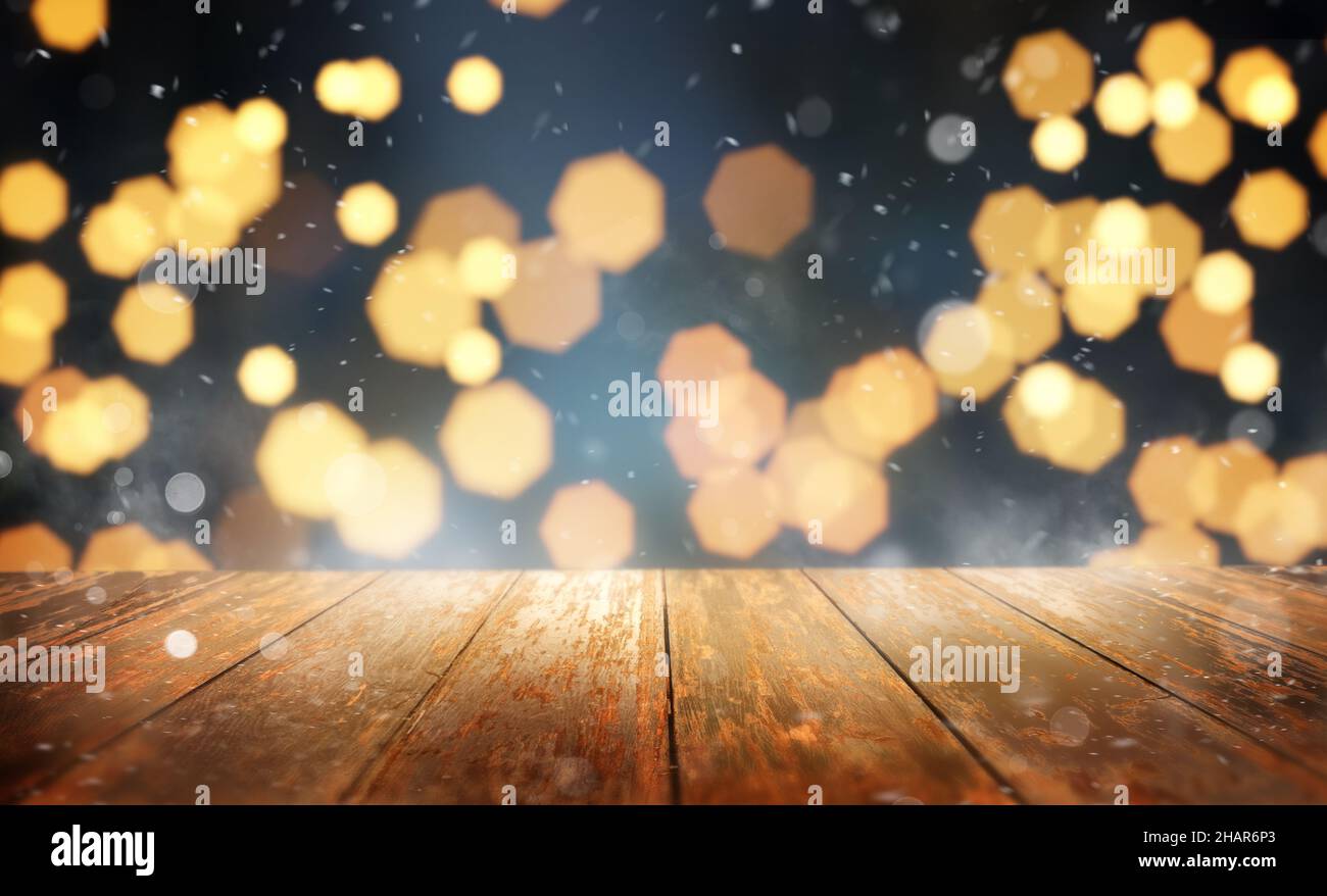 Festive Chrsitmas background with warm glowing lights and a empty wooden table. Stock Photo