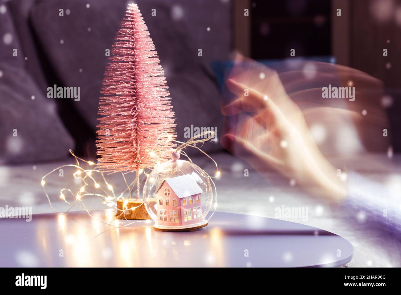 Hand, Pink Christmas Tree. Falling Snowflakes At New Year 2022 Evening Very Peri Stock Photo - Alamy