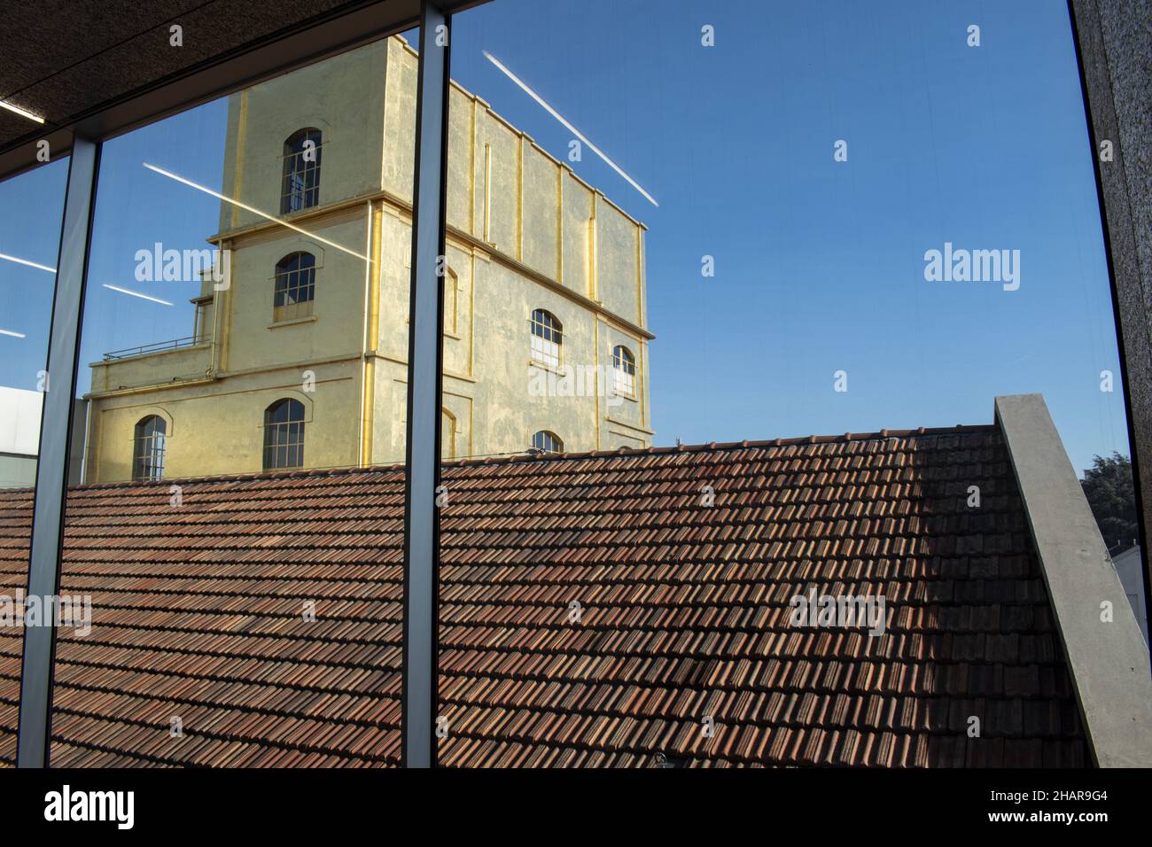Milan, Italy: The Haunted House designed by Rem Koolhaas, covered with a layer of gold leaf, seen from inside one of the buildings of Fondazione Prada Stock Photo
