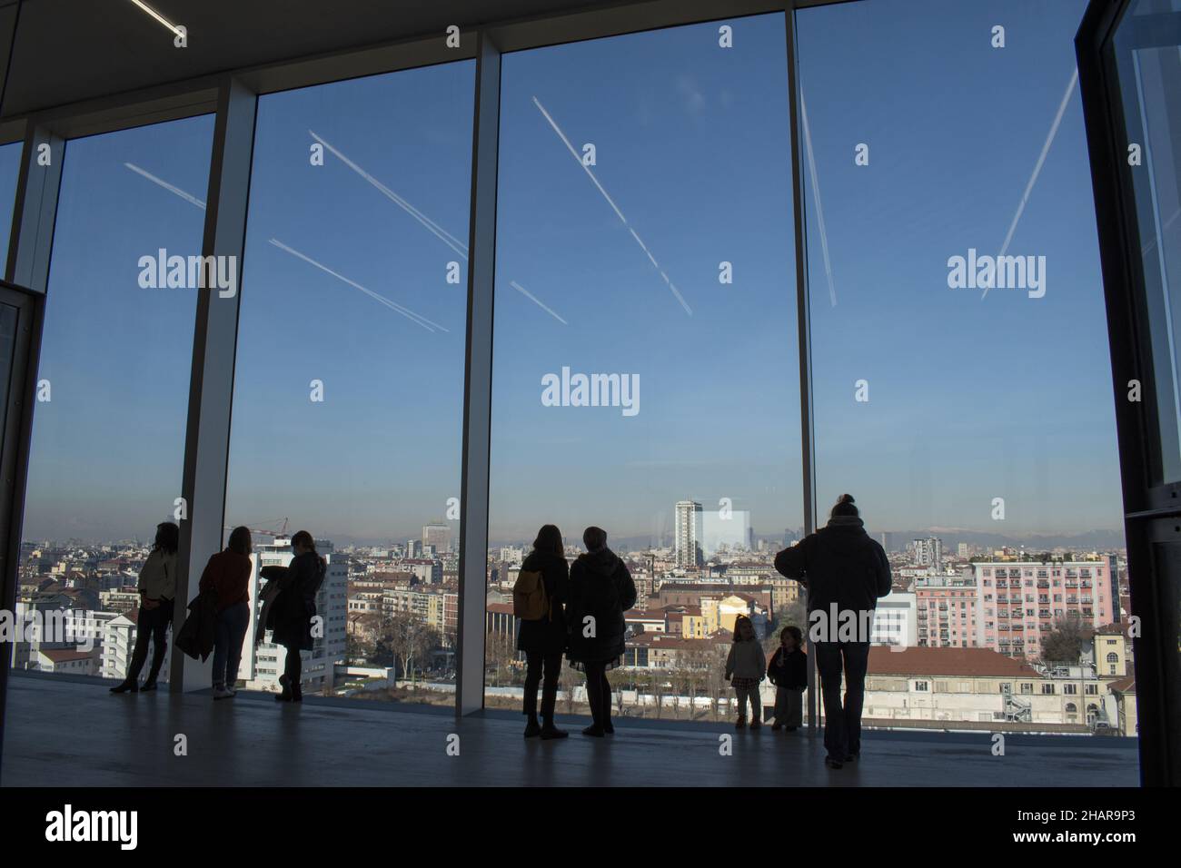 Milan, Italy: People in front of the windows on the skyline from the Tower of Fondazione Prada, the building 60 meters high designed by Rem Koolhaas Stock Photo