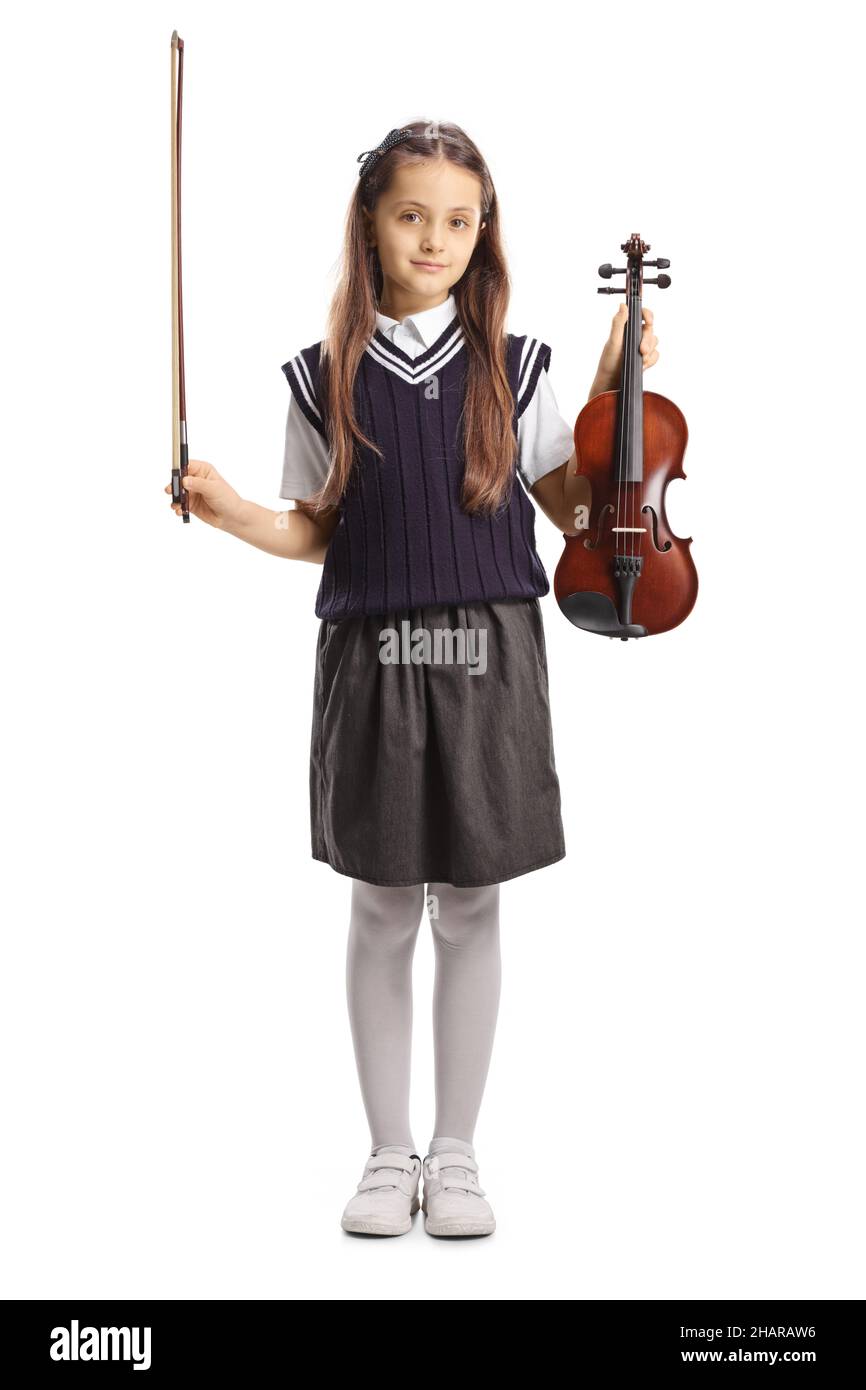 Full length portrait of a girl in a school uniform holding a violin ...