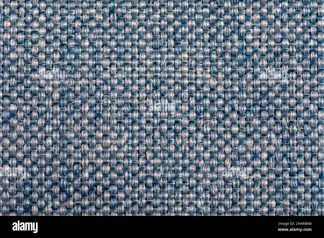 Blue fabric texture. Furniture upholstery textiles. Embossed pattern. Woven fibers. The material is soft touch. Minimalism concept. High detail macro Stock Photo