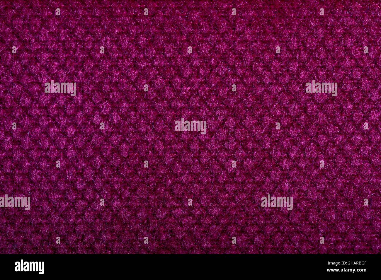Purple fabric texture. Furniture upholstery textiles. Embossed pattern. Woven fibers. The material is soft touch. Minimalism concept. High detail macr Stock Photo