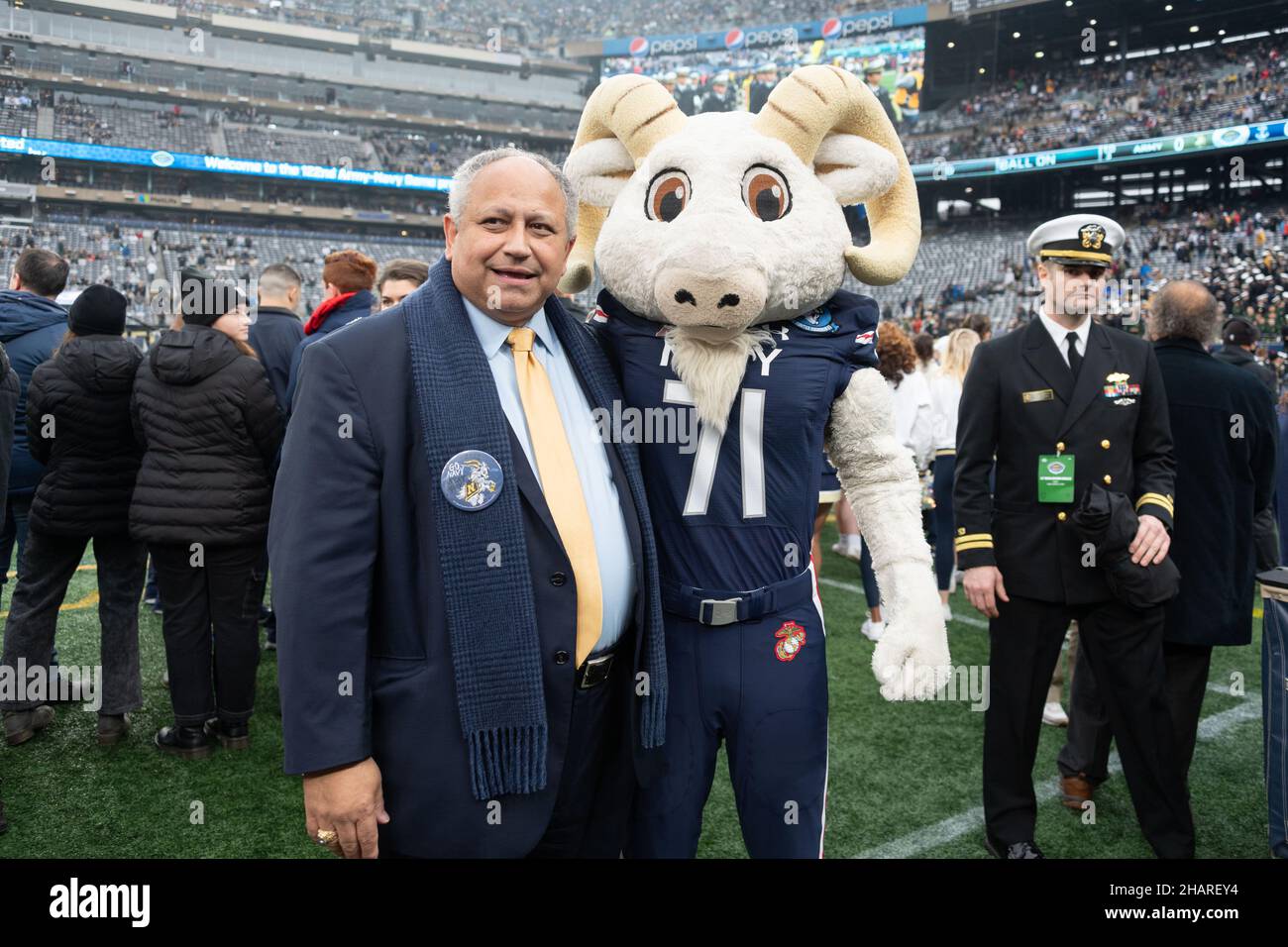 East Rutherford, United States of America. 11 December, 2021. U.S. Secretary of the Navy Carlos Del Toro cheers on the crowd with Naval Academy costumed mascot Bill the Goat, during the start of the annual Army-Navy football game at Metlife Stadium December 11, 2021 in East Rutherford, New Jersey. The U.S. Naval Academy Midshipmen defeated the Army Black Knights 17-13 in their 122nd matchup.  Credit: Stacy Godfrey/U.S. Navy Photo/Alamy Live News Stock Photo