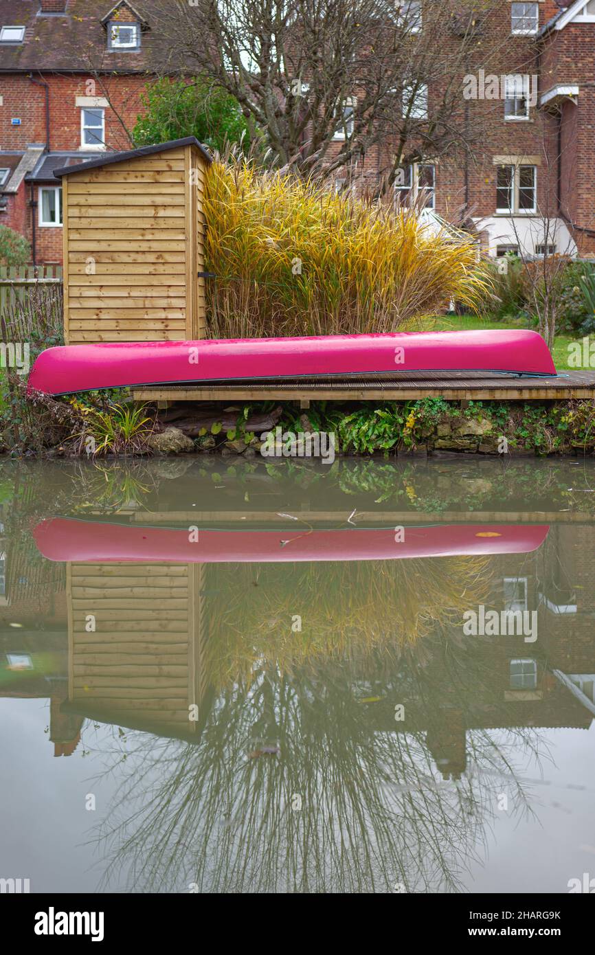 A kayak or canoe moored alongside a garden adjoining the Oxford