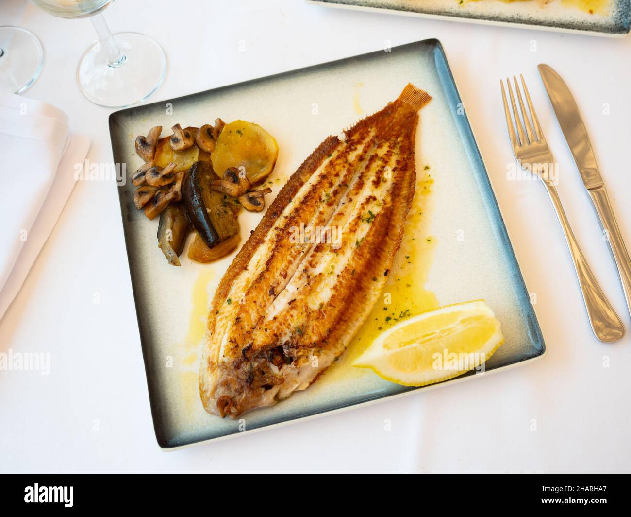 Grilled common sole with lemon and baked vegetables Stock Photo Alamy