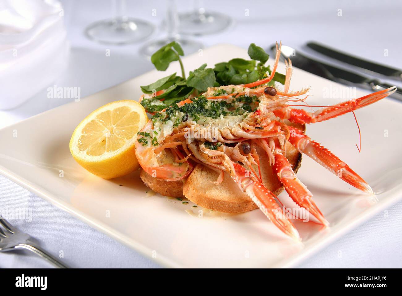Langoustine Norway lobster Dublin Bay prawn scampi with herb butter lemon and salad Stock Photo