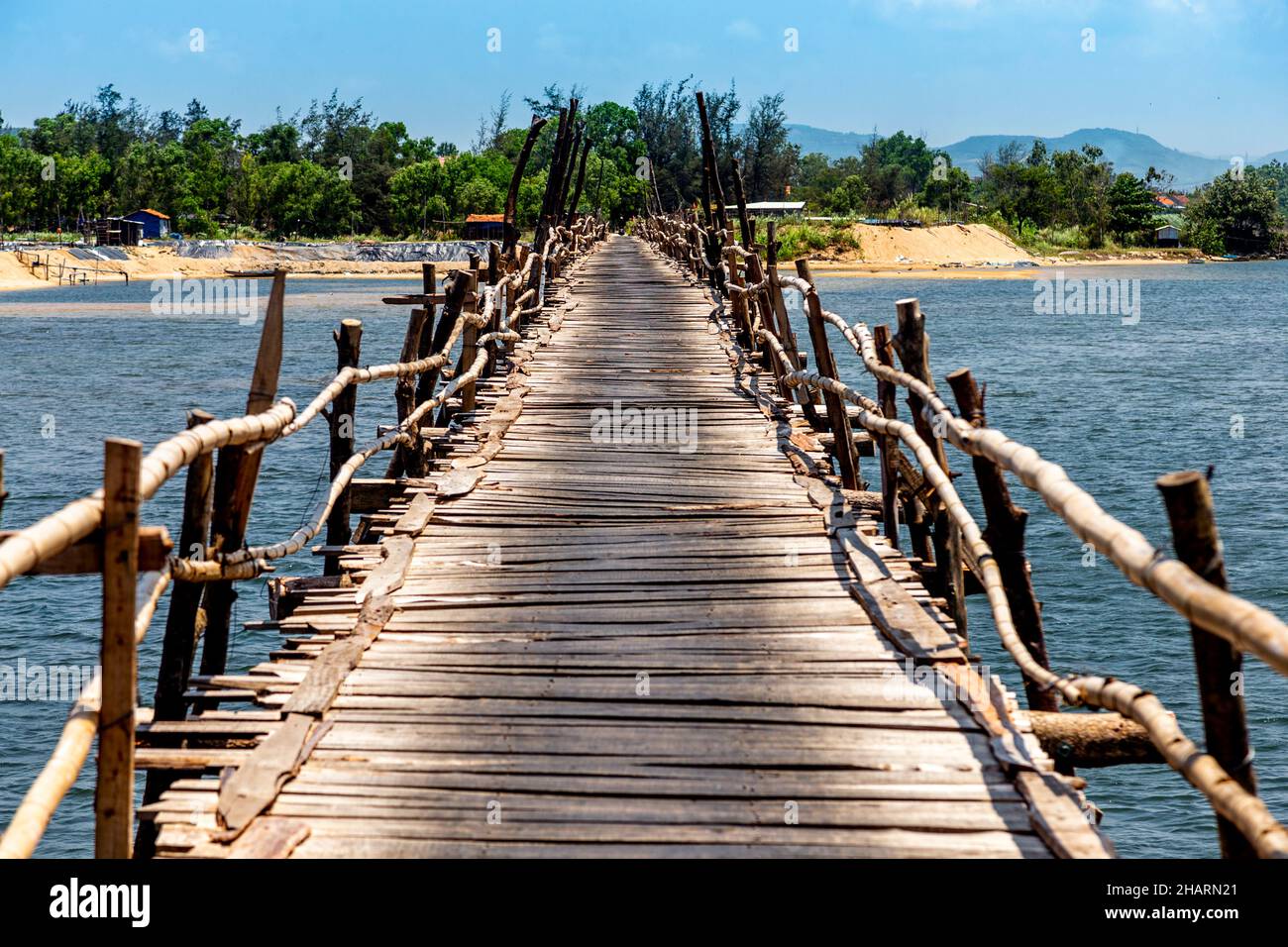 Wooden bridge crosses water in Central Vietnam Stock Photo - Alamy
