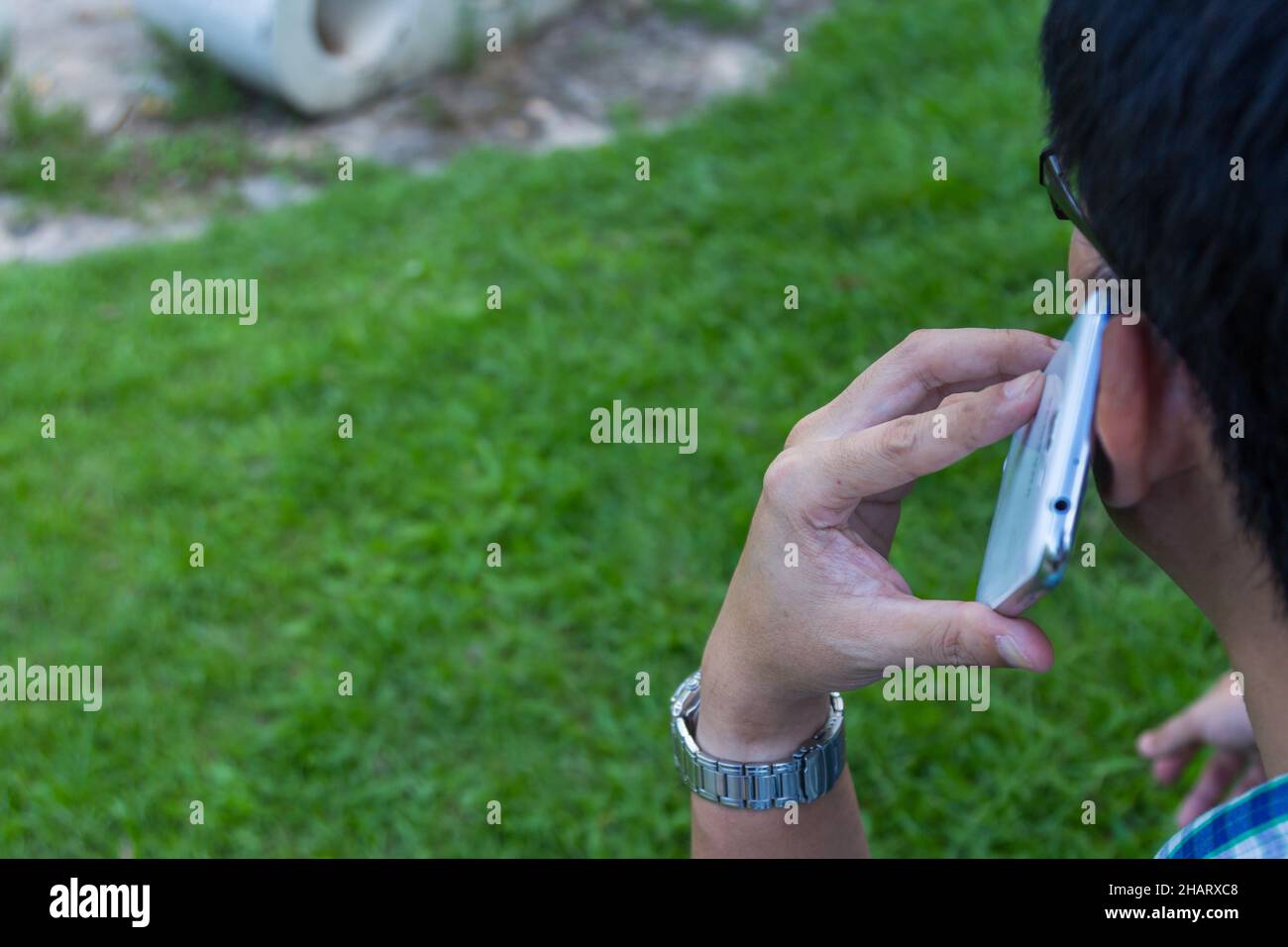 Close up man using mobile smart phone with green background Stock Photo ...