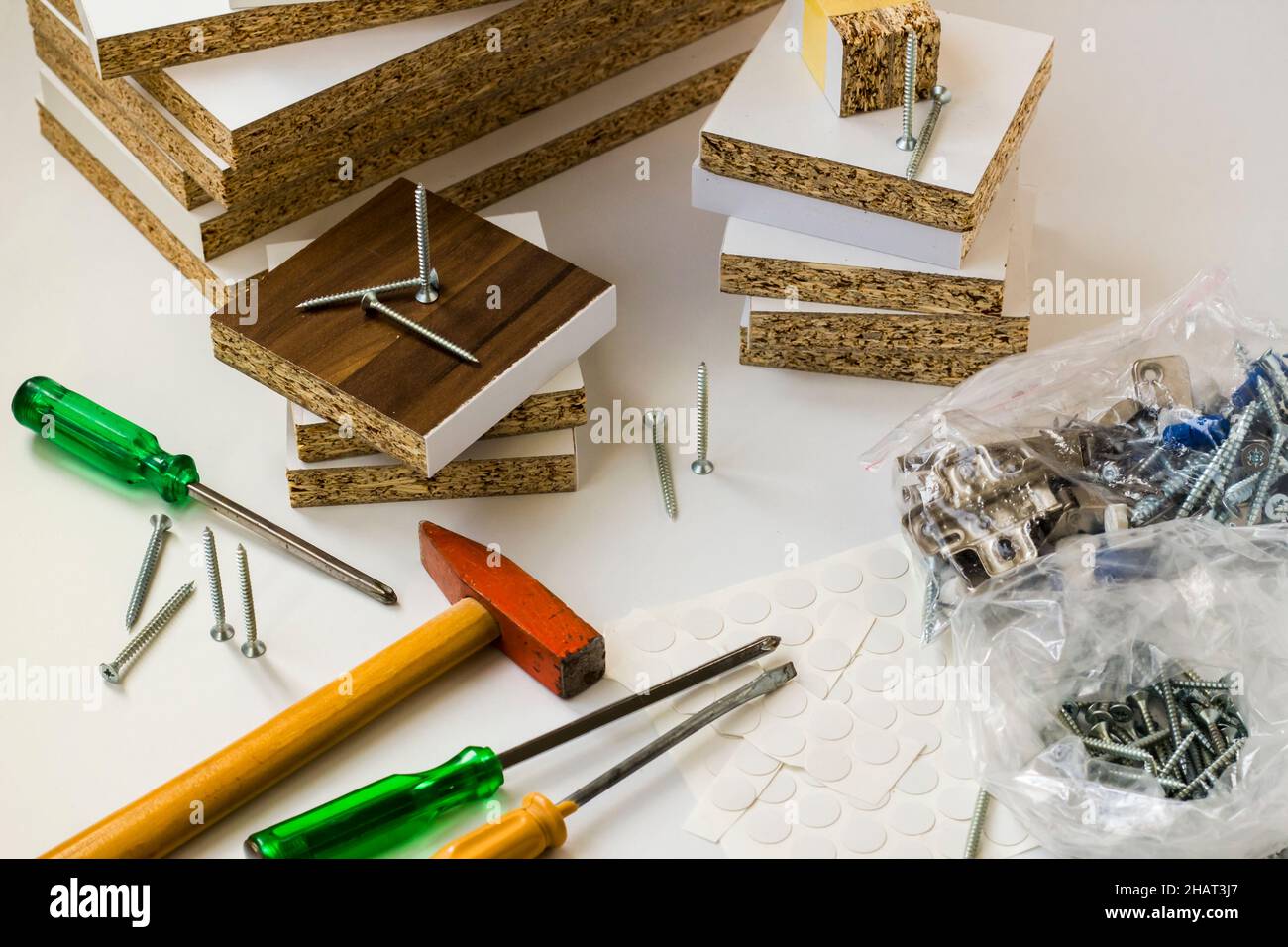 White color disassembled furniture parts will be installed manually