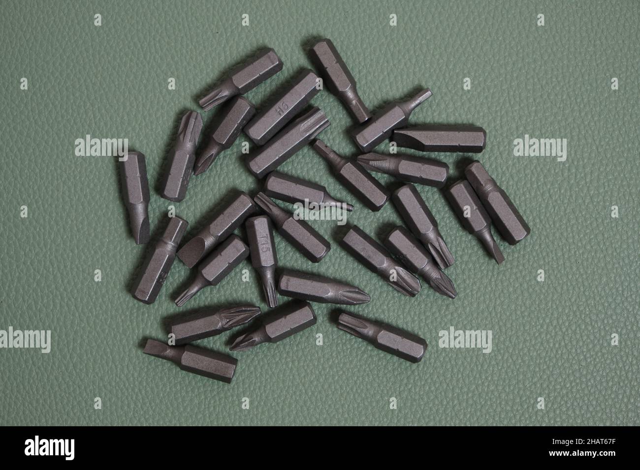 Set of screwdriver bits on a green background Stock Photo