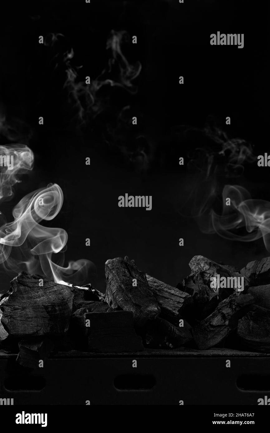 Extinguished coals on grill barbecue on black background with white ...
