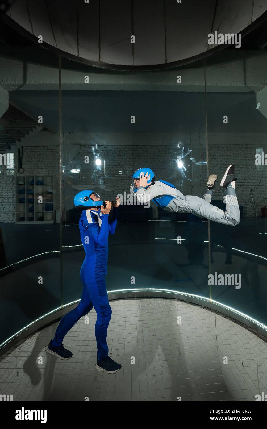 A man and a woman enjoy flying together in a wind tunnel. Free fall ...