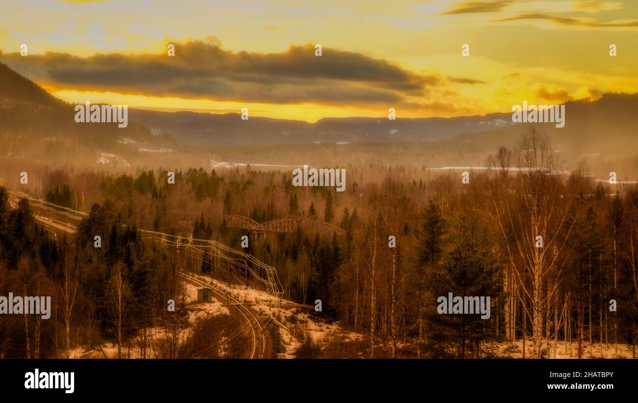 mountain landscape with bridges and railroad during sundown Stock Photo