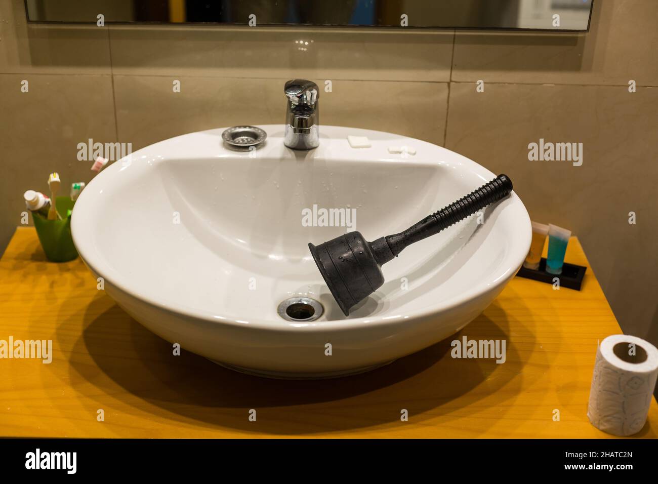 Closeup of plumbers using plunger in bathroom sink Stock Photo Alamy