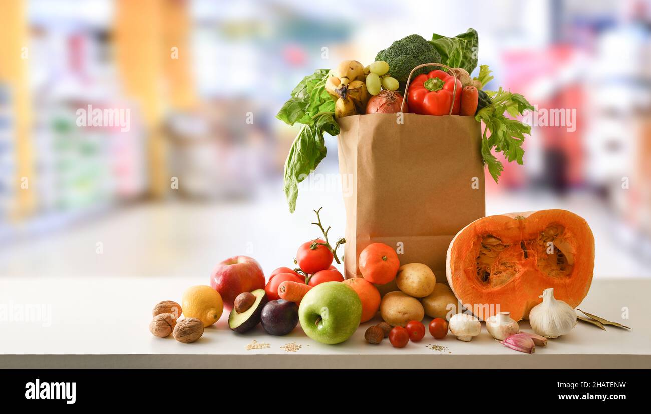 Recyclable shopping bag with fruits and vegetables on table and
