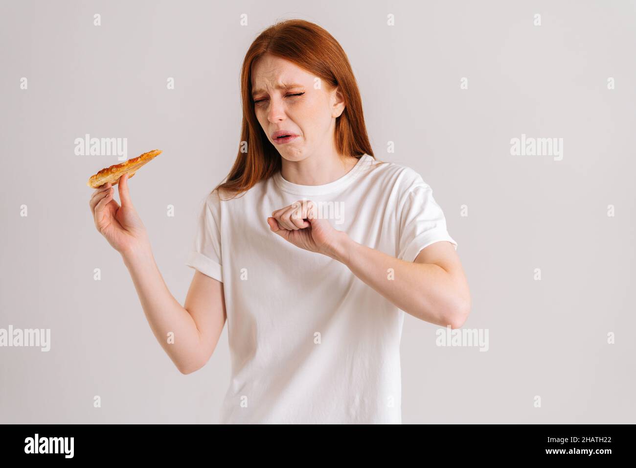 Studio portrait of scared young woman suffering from choking and cough