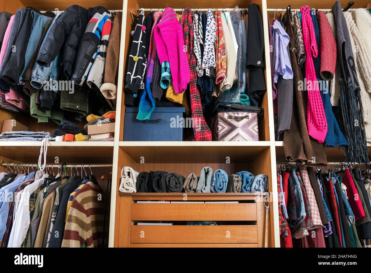 https://c8.alamy.com/comp/2HATHNG/collection-of-multicolored-assorted-clothes-placed-accurately-on-rails-and-hangers-with-shelves-in-walk-in-closet-2HATHNG.jpg
