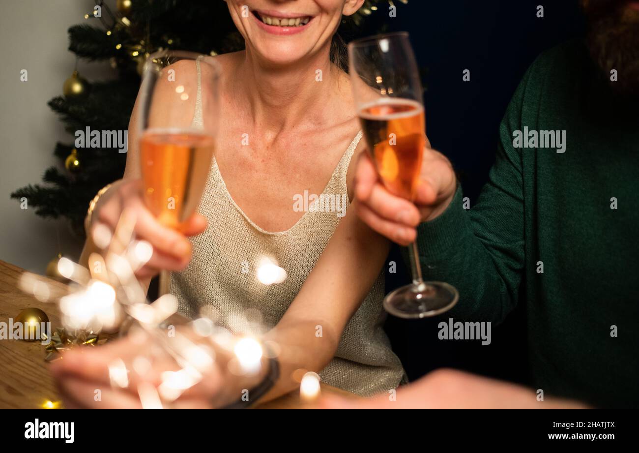 happy couple holding sparkles and champagne glasses New Year party Stock Photo
