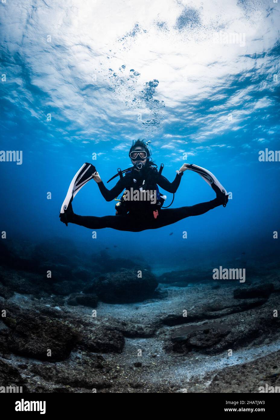 Scuba Diver doing splits underwater Stock Photo