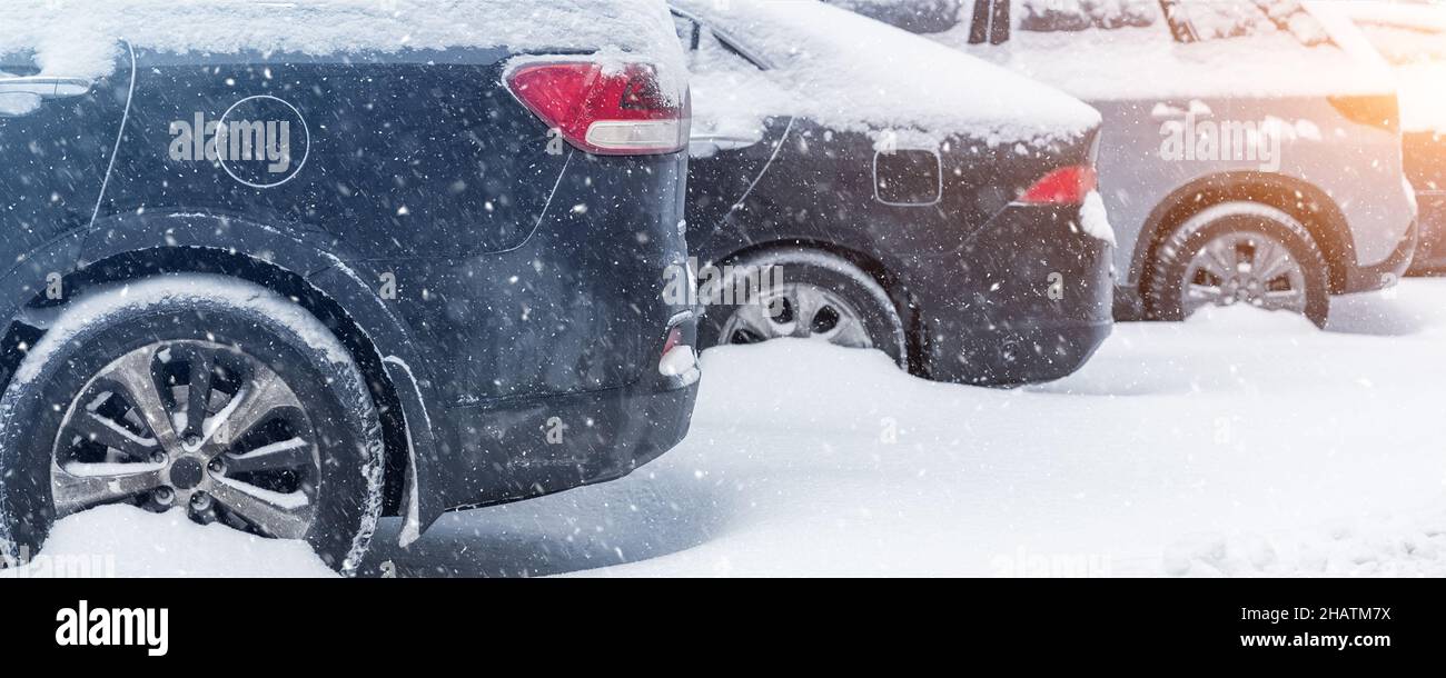 City street driveway parking lot with many cars covered by snow stucked ...