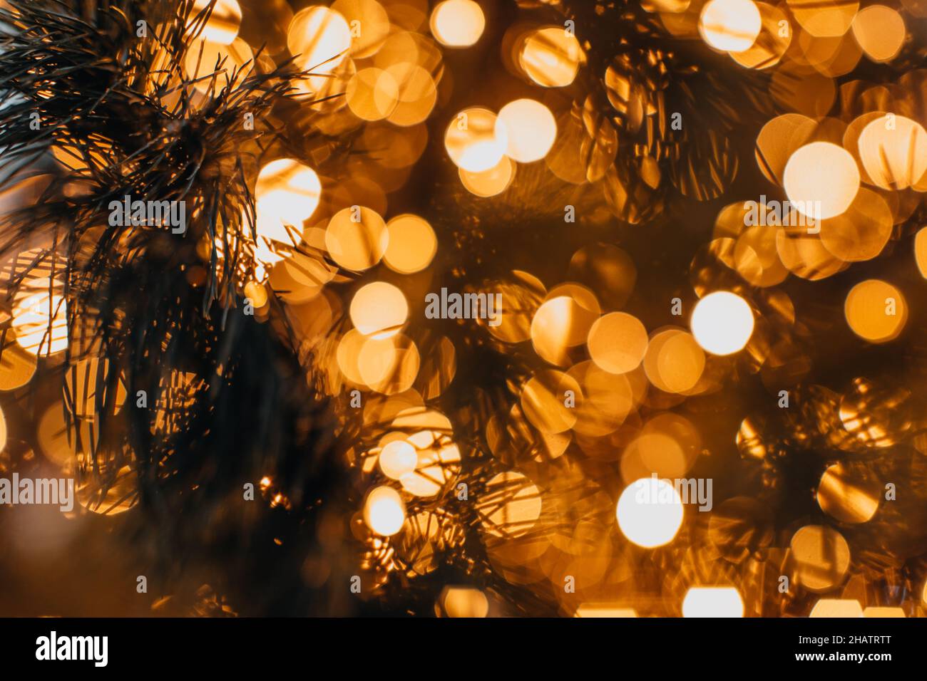 Golden magic glittering blurry bokeh lights of garland. Christmas and New Year festive background Stock Photo