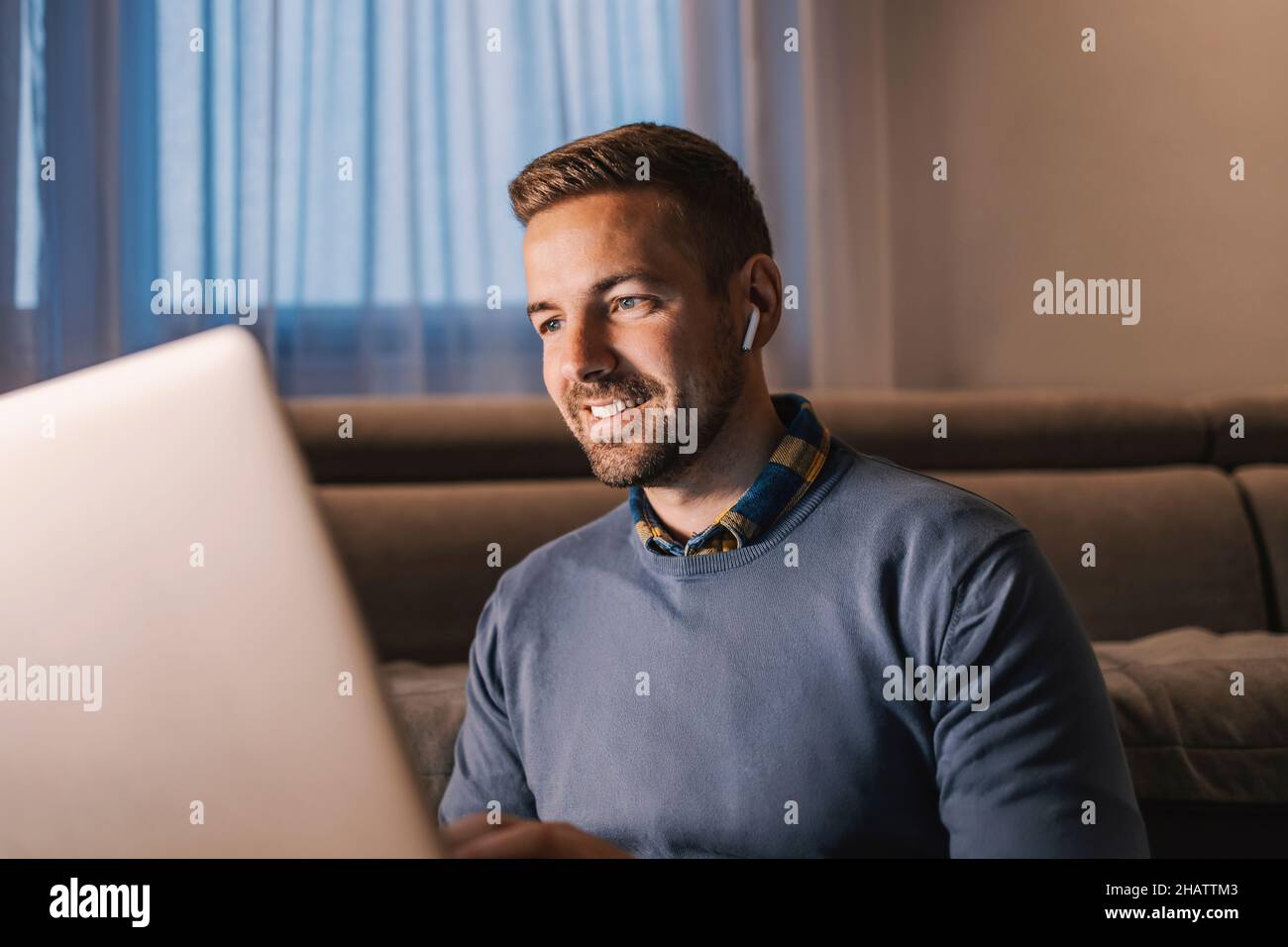 Data entry, software engineering, and remote business. A happy senior developer with earphones typing on his laptop code and trying out new technologi Stock Photo