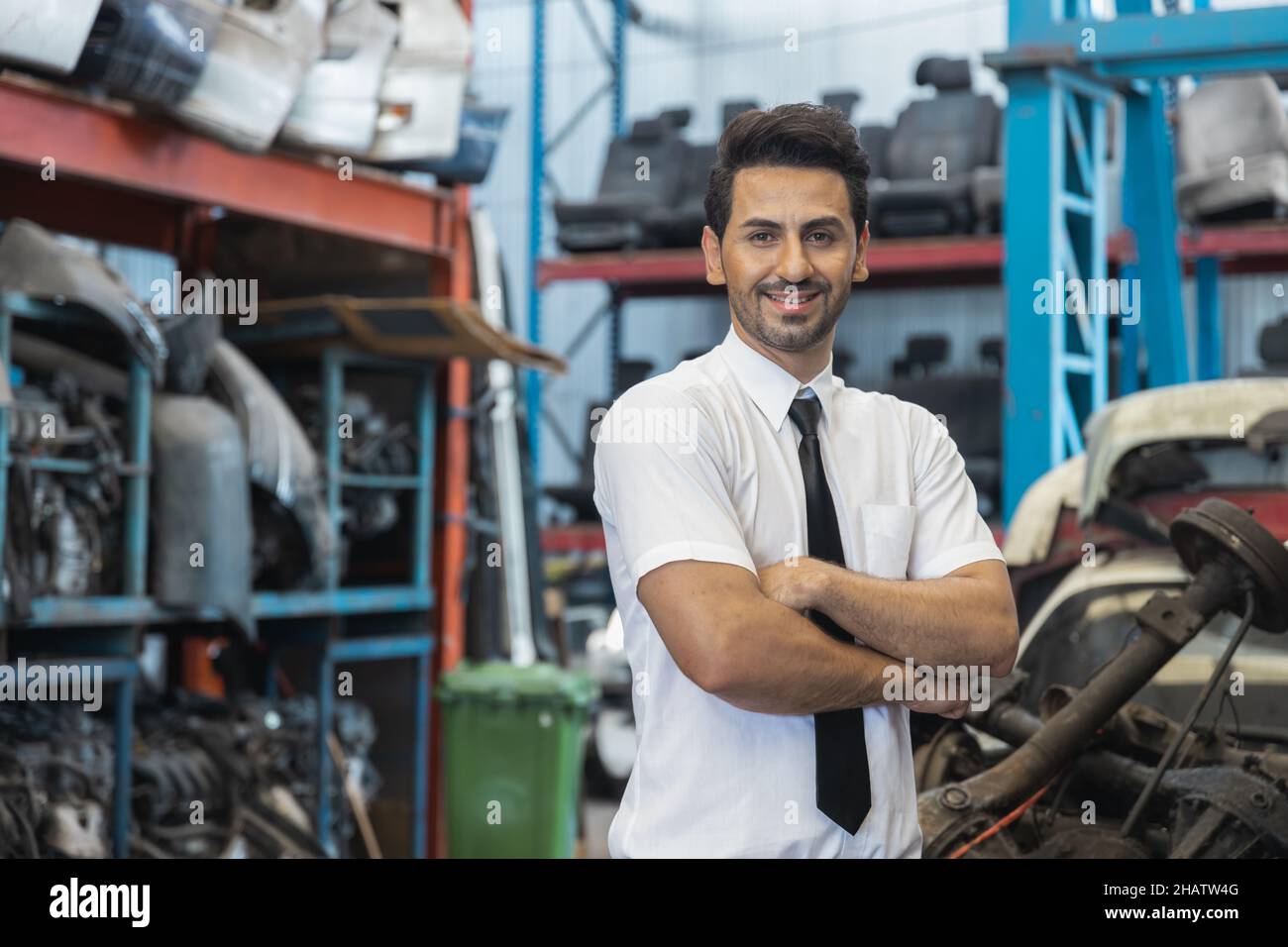 Portrait of confident business man in old parts of car factory Stock Photo