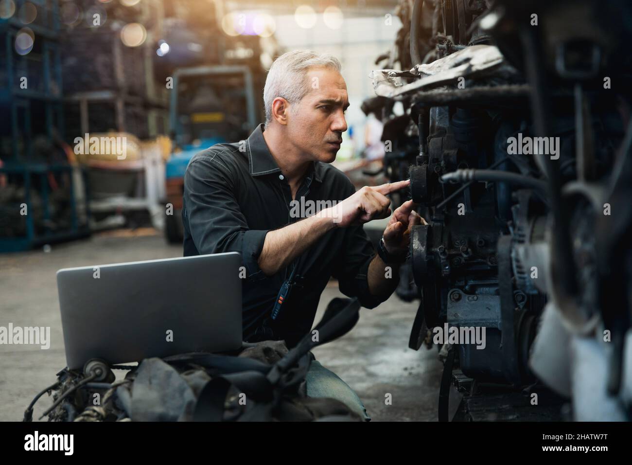 Engineer mechanic working and check engine by computer laptop and ...