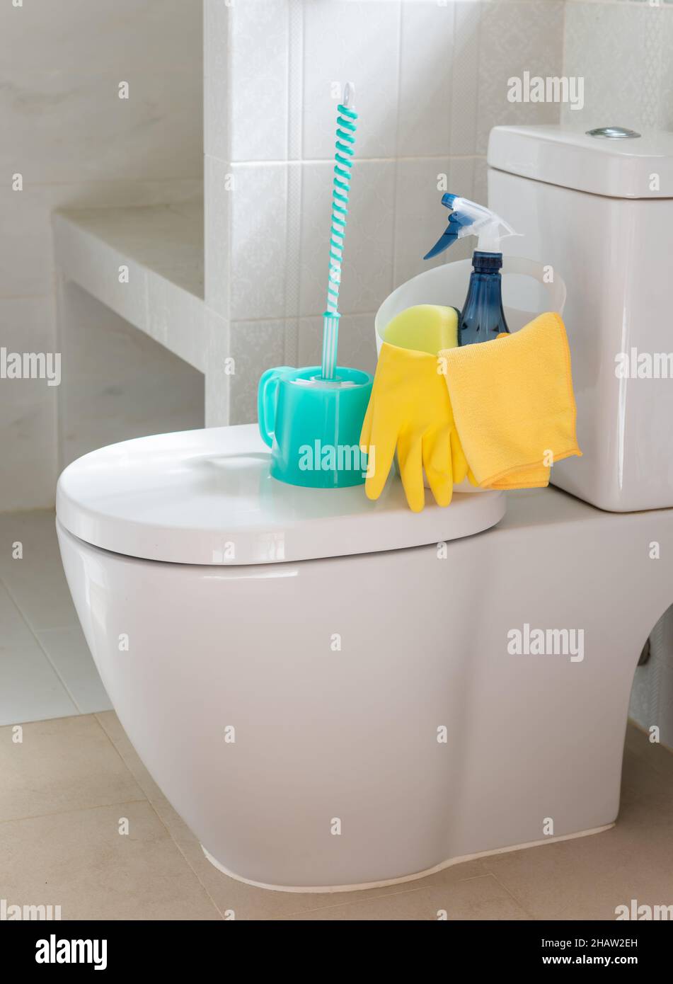 Basket of cleaning supplies on toilet bowl in modern bathroom Stock ...
