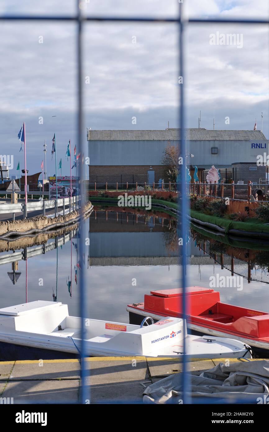 Through a fence over tourist rental boats Mini port towards RNLI
