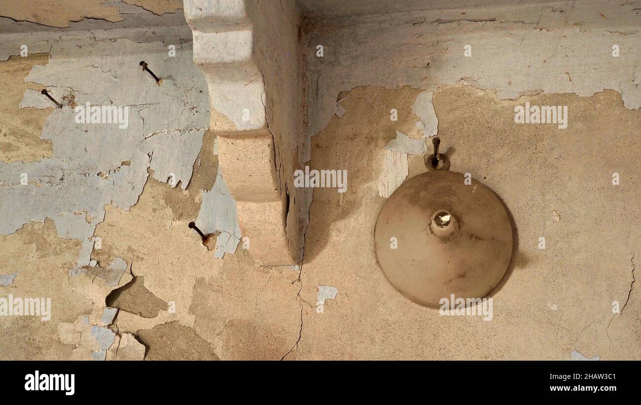 Funnel on shabby wall with nails, old wall with peeling paint and funnel Stock Photo