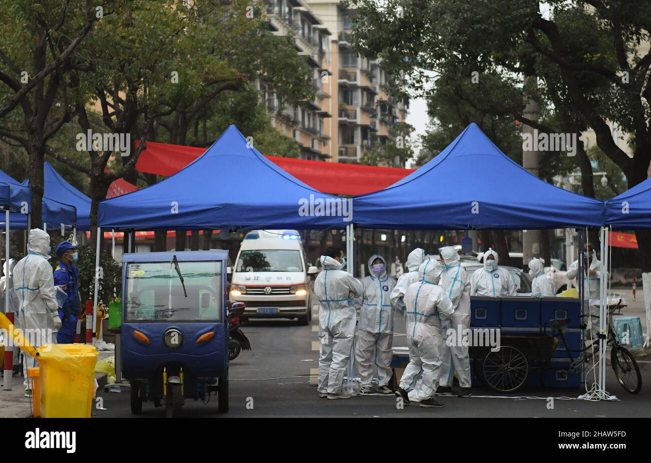 Hangzhou, China's Zhejiang Province. 14th Dec, 2021. Staff members and an ambulance are seen at a residential area under closed-off management in Shangyu District of Shaoxing, east China's Zhejiang Province, Dec. 14, 2021. Credit: Weng Xinyang/Xinhua/Alamy Live News Stock Photo