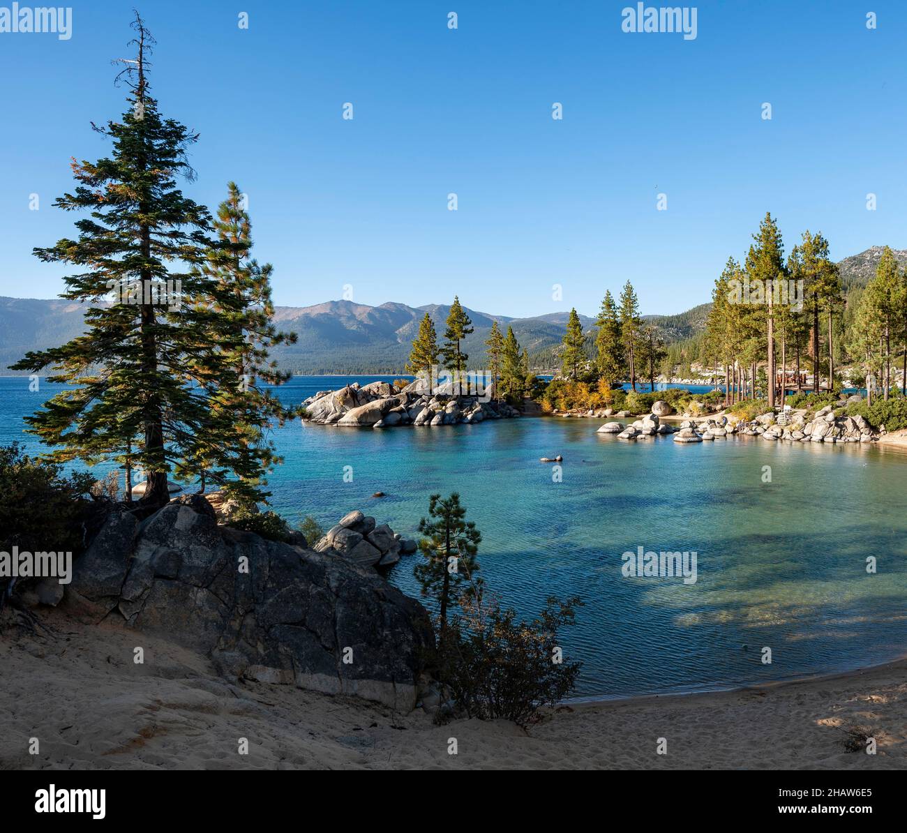 Sand beach and round stones in the water, bay at Lake Tahoe, Sand