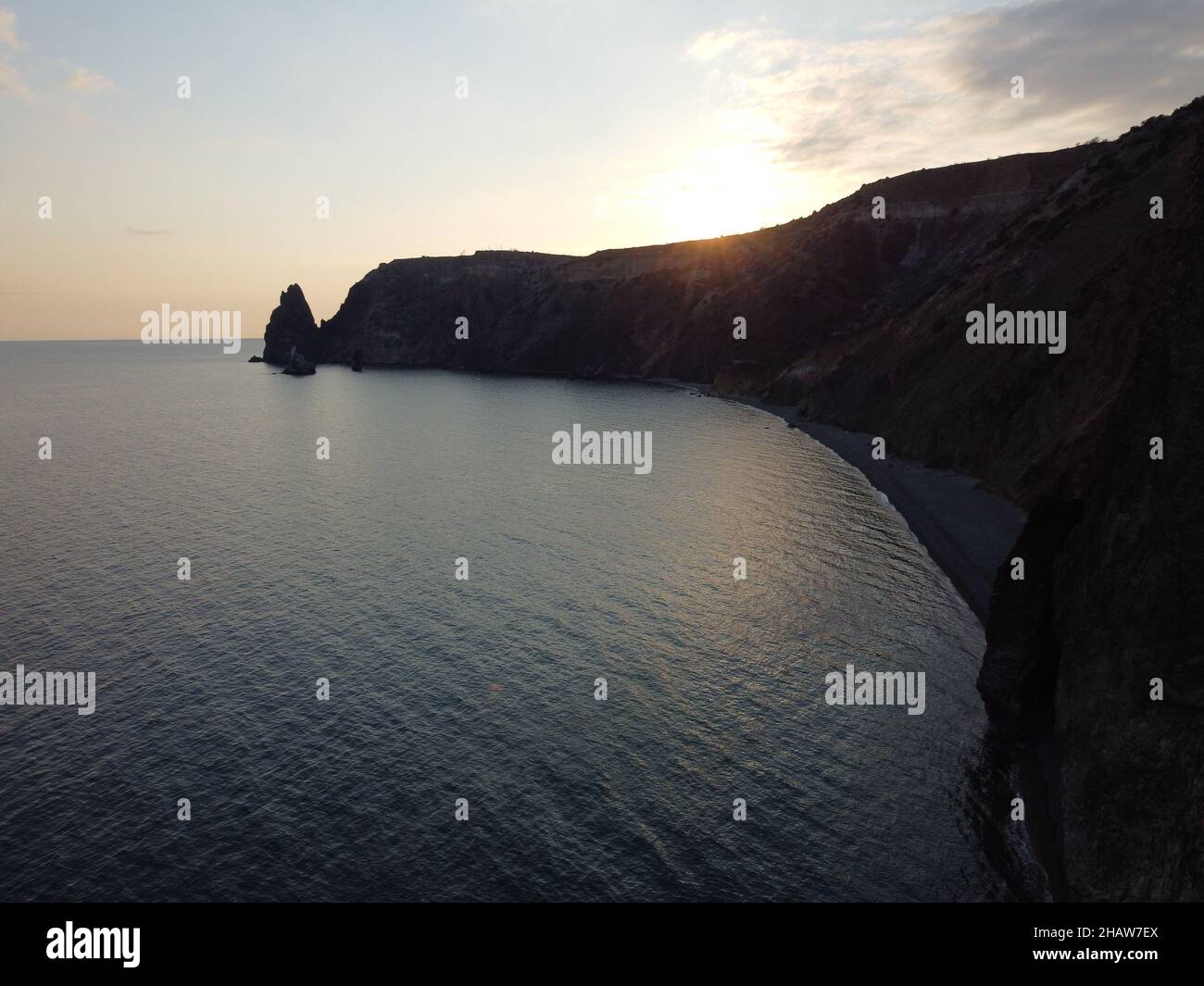 Aerial view from above on calm azure sea and pebbles beach. Small waves on cristal clear water surface in motion blur. Summer ocean sea beach Stock Photo