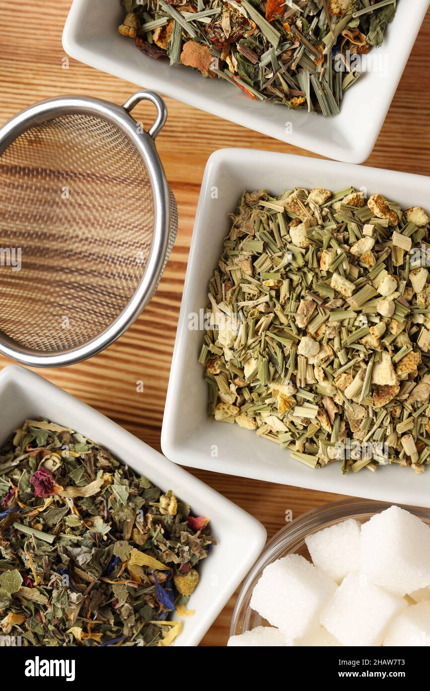 Concept of cooking tea with different types of tea on wooden background ...