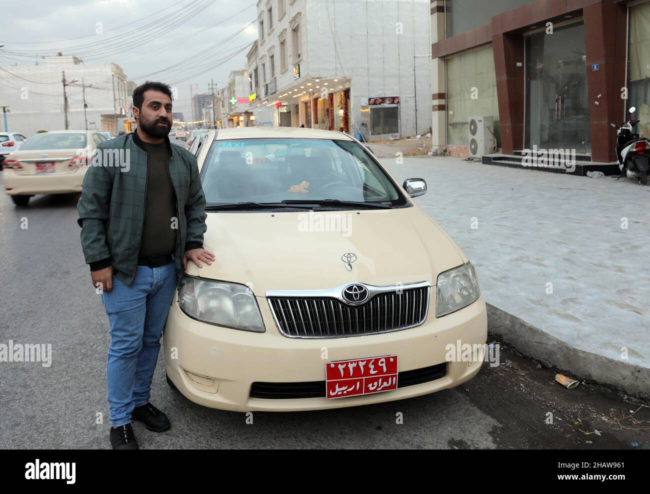 Erbil. 15th Dec, 2021. Aram Majeed stands by his taxi in Erbil, Iraq