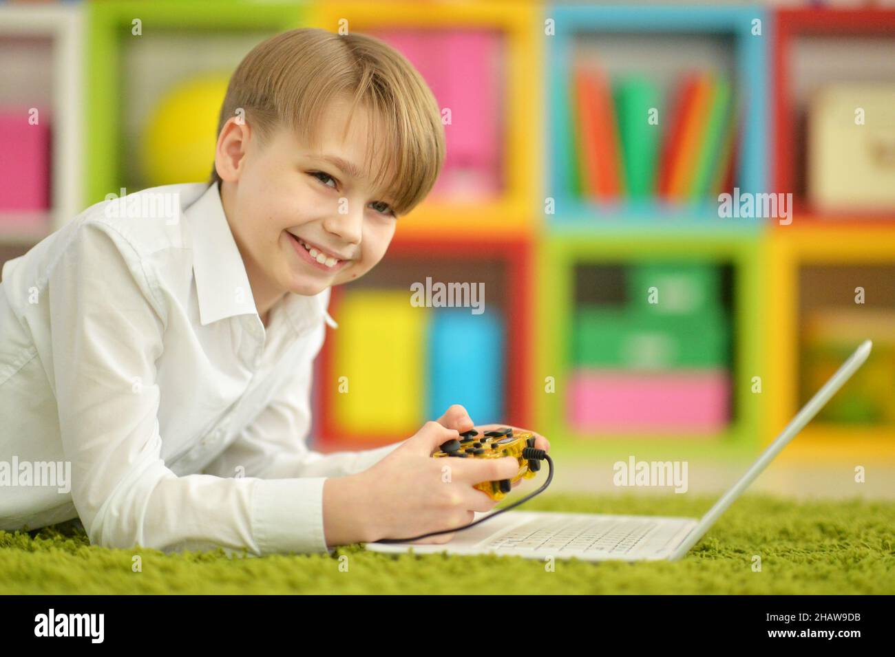 Portrait of boy playing video game on laptop Stock Photo - Alamy