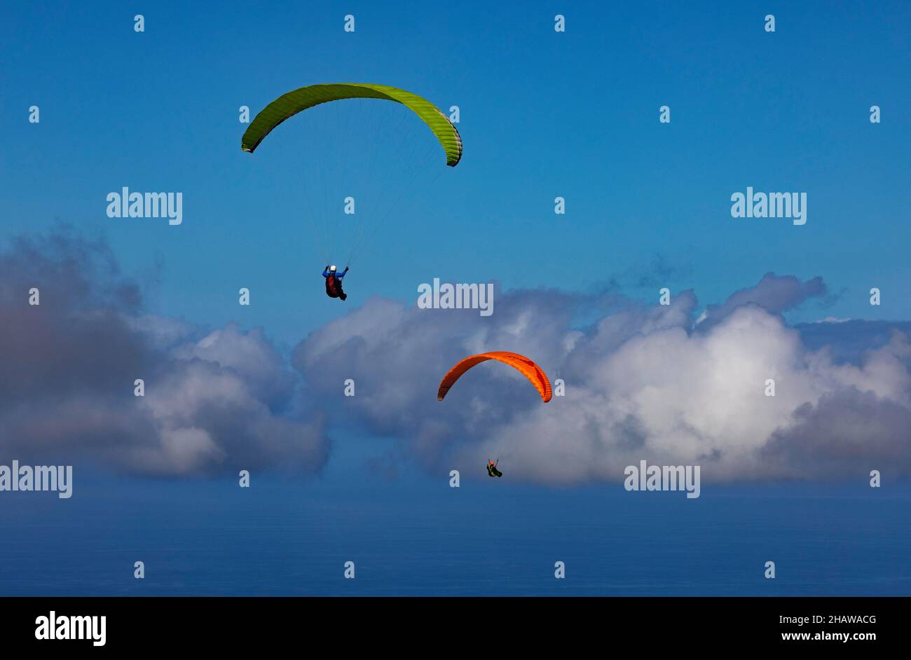 Paraglider with dramatic cloudy sky after take-off from Pico Barrosa, Sao Miguel Island, Azores, Portugal Stock Photo