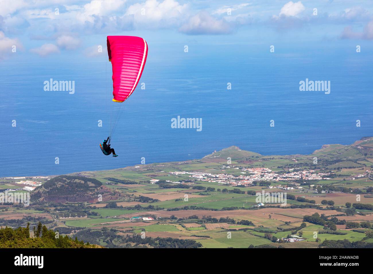 Paragliders after take-off from Pico Barrosa with a view over the island of Sao Miguel, Azores, Portugal Stock Photo