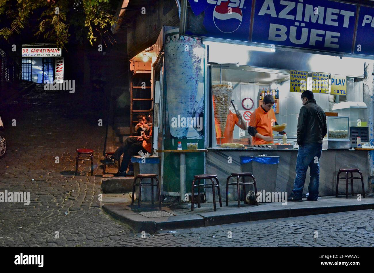 Kebab shop illuminated at night with vendor and customers, kebab shop at night, Eminoenue district, Istanbul, Turkey Stock Photo