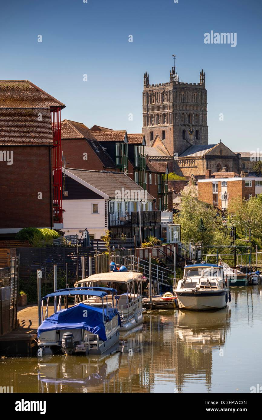 UK, England, Gloucestershire, Tewkesbury, boats moored on Mill Avon, Abbey in distance Stock Photo