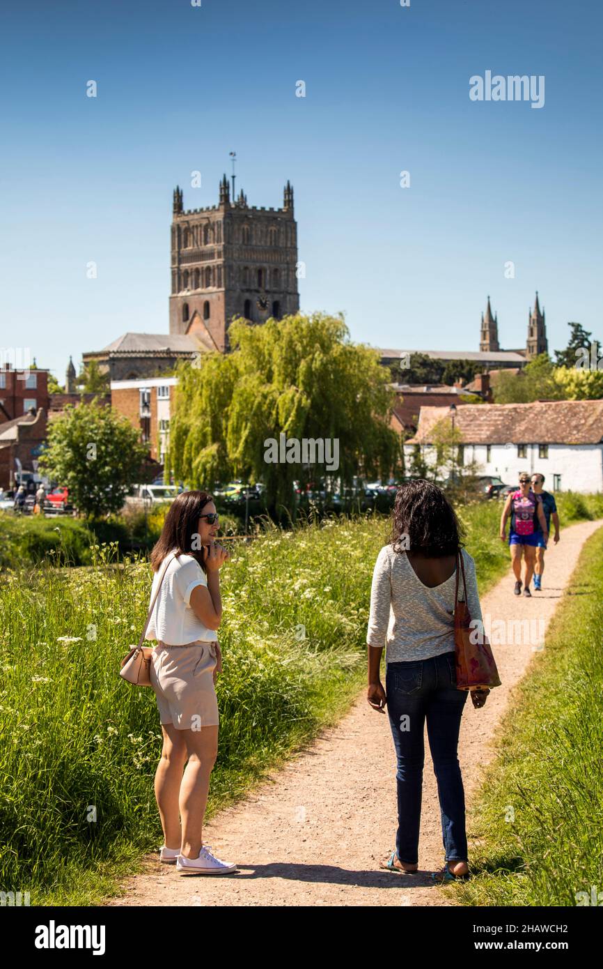 UK, England, Gloucestershire, Tewkesbury, Severn Ham, visitors on Severn Way path, Abbey in distance Stock Photo