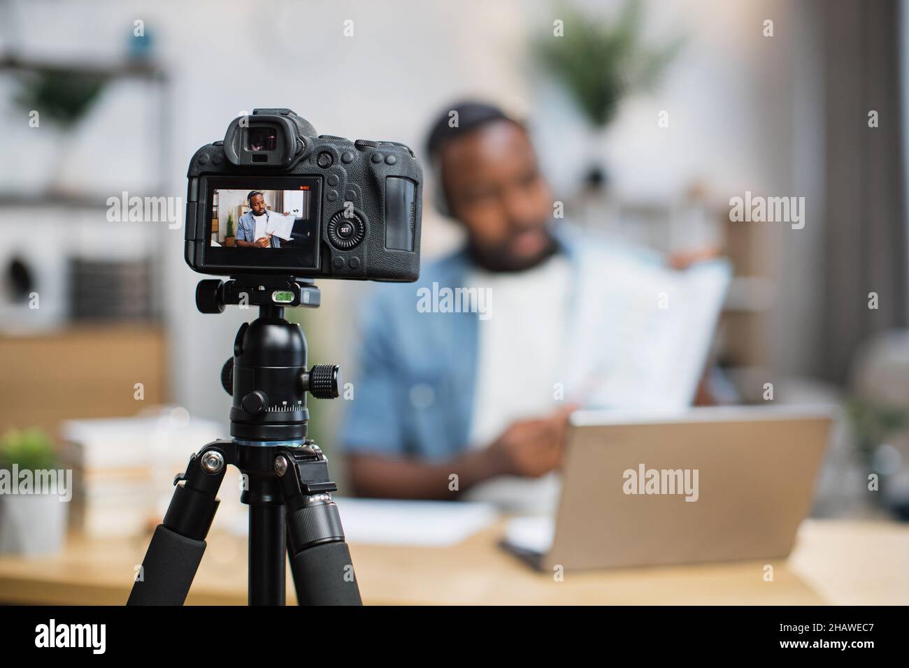 Blur background of african man in headset presenting financial report  during online conference. Business person using laptop and digital camera  for re Stock Photo - Alamy