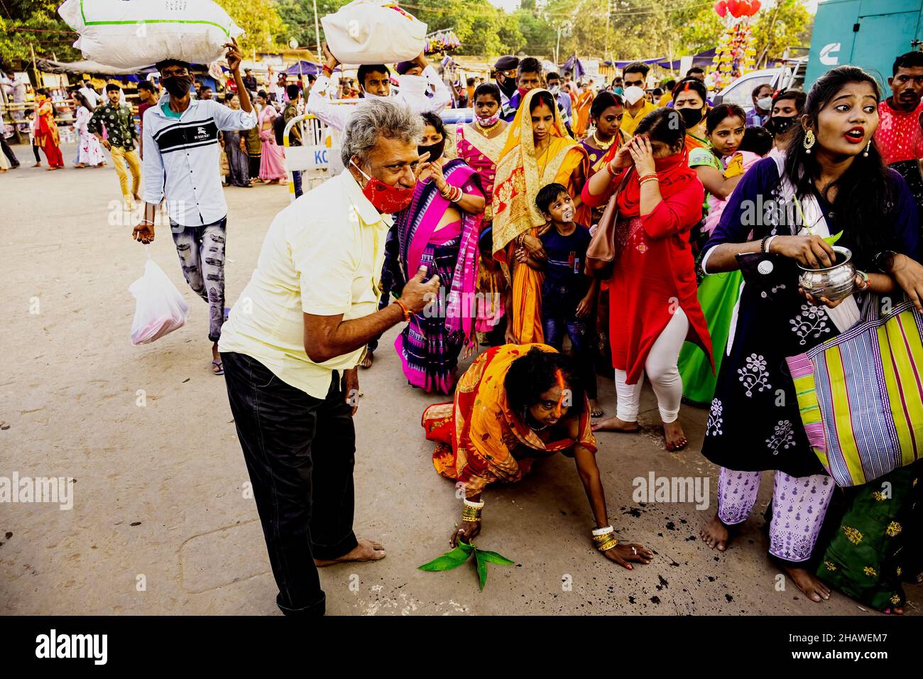 Kolkata,Babughat,Chhat Puja,scene,Aged,female,doing,Dandee penance,before,reaching,river,Ganga,India. Stock Photo