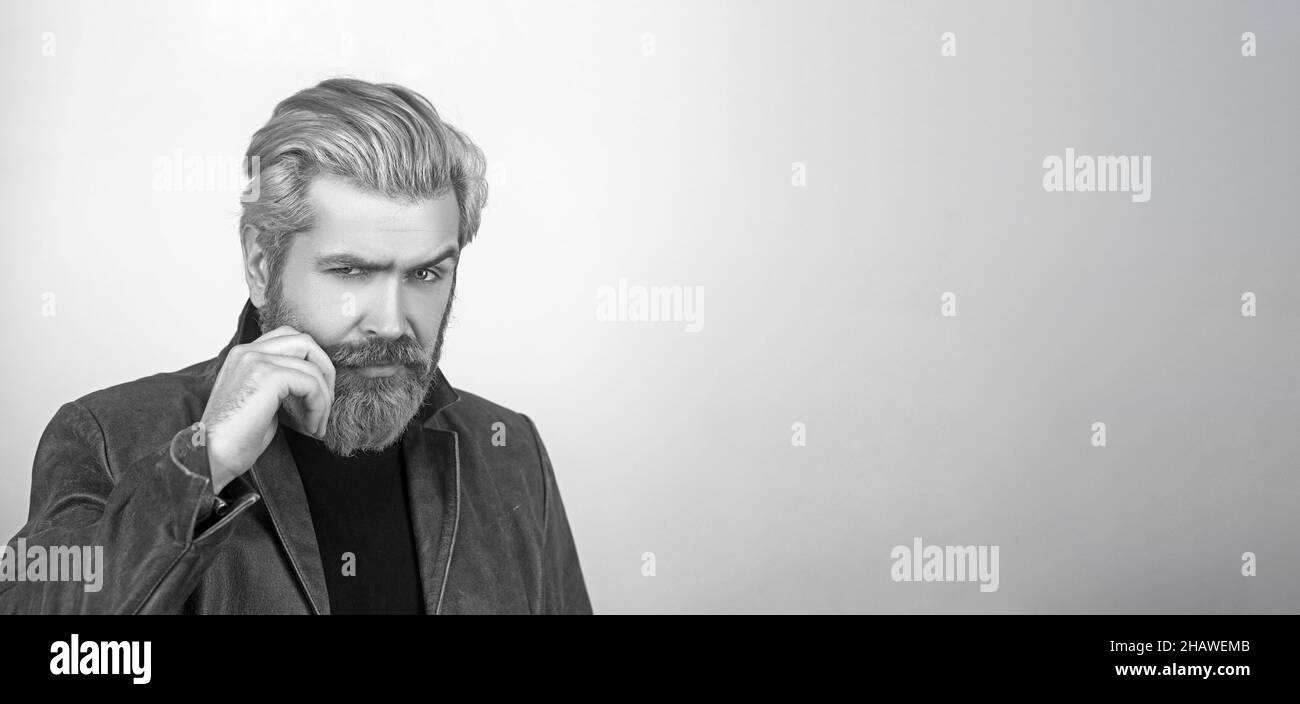 Attractive young man with leather jacket looking at camera. Stock Photo